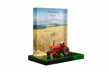 Die-cast tractor in front of a wheat field backdrop