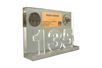 Clear cut plexiglass “135” in front of a clear Lucite panel with coin & card embedments