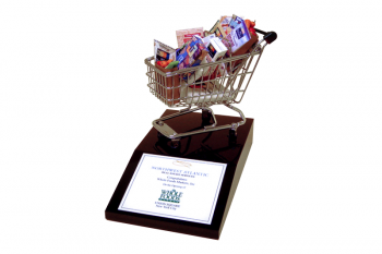 Miniature shopping cart and groceries on a black Lucite base