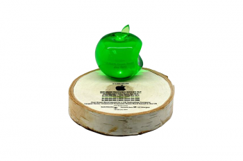 Green crystal apple on a slice of birch